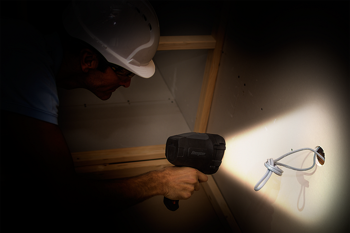 a man checking cables in the dark with the Energizer HardCase Spotlight