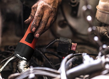 a mechanic checking the car engine with the Energizer Intrinsically Safe Flashlight