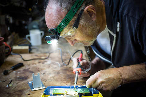 a man wearing an Energizer Vision Ultra HD Rechargeable Industrial Headlamp welding a machine