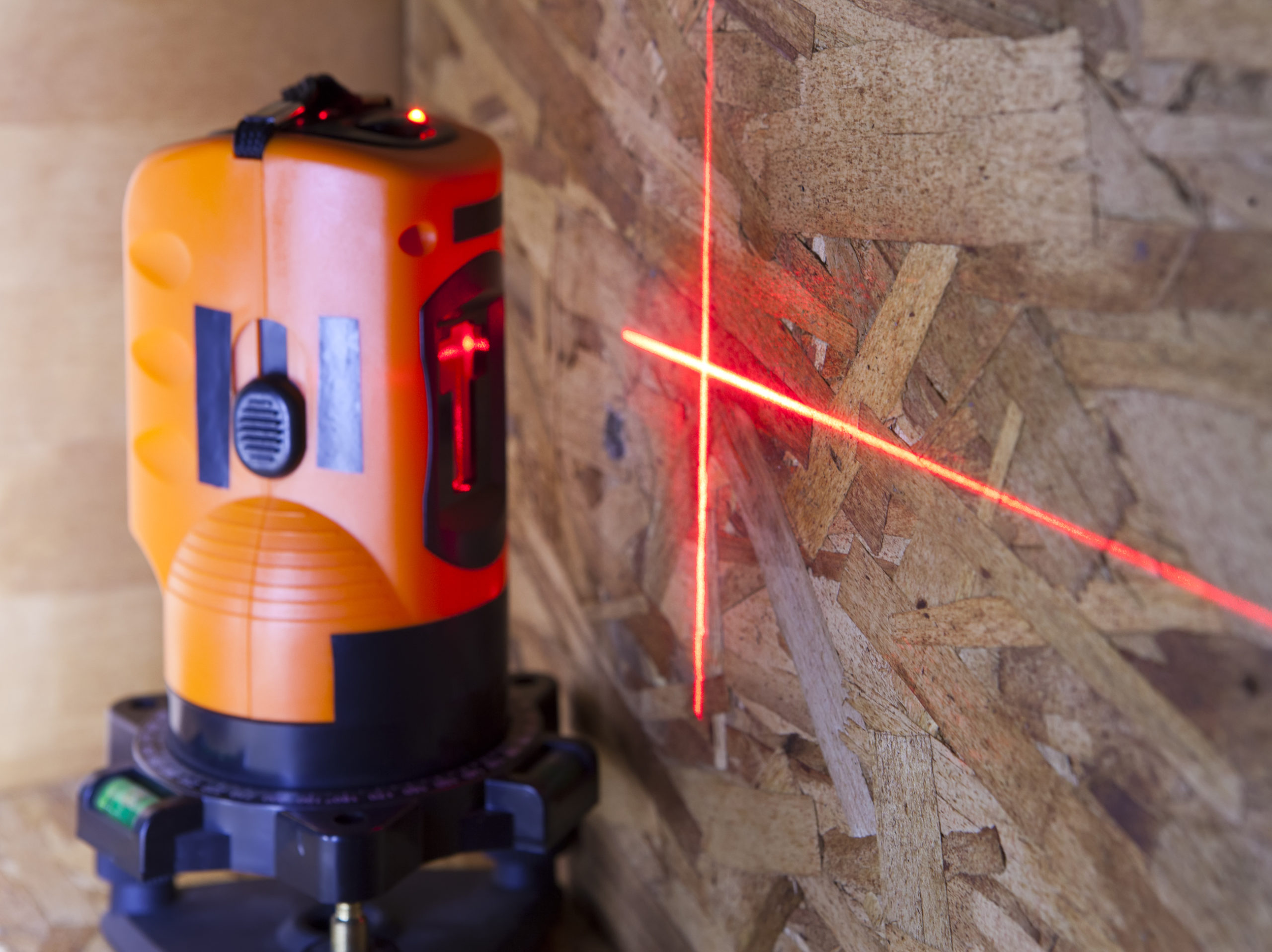 an orange laser measurement level for construction
